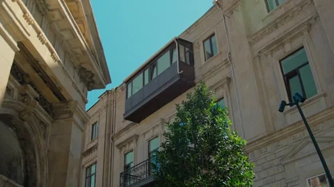 Daytime View of Historic Building Facade with Balcony and Trees Stock Footage 338243423