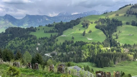 Daytime view from Moléson mountain overlooking valley with parking, houses, and  Vídeos de archivo 309142995