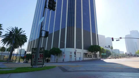 Daytime view of a street corner in Los Angeles with tall buildings and palm.. Stock Footage 286417897