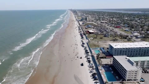 Daytona Beach, Florida with waves from the Atlantic Ocean, vehicles, hotels and Stock-Footage 309850378