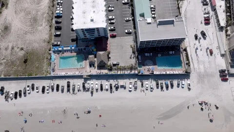 Daytona Beach, Florida with waves from the Atlantic Ocean, vehicles, hotels and Stock-Footage 309850464