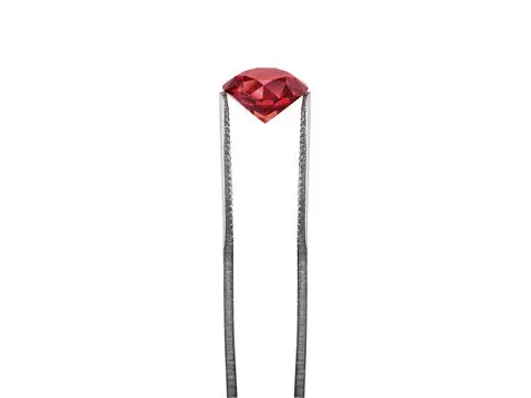 Dazzling diamond red on white background held in diamond tweezers. 3d render Stock Photos