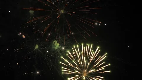 Dazzling fireworks blasts fill dark night sky with shimmering flame traces Stock Footage 266167267
