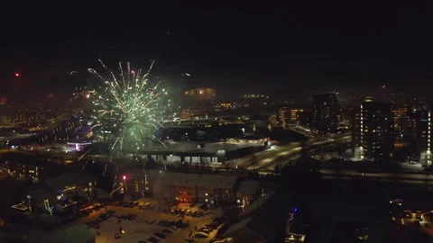 Dazzling Fireworks Exploding On New Year's Eve In Iceland. orbiting drone shot Stock Footage 306276084