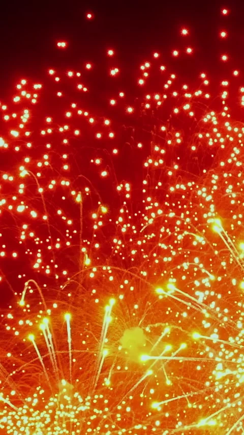 Dazzling fireworks light up the night sky over the city in vibrant hues Stock Footage 334923049