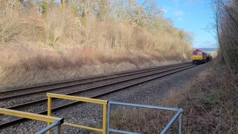 DB Schenker freight train passes foot crossing 動画素材 229986883