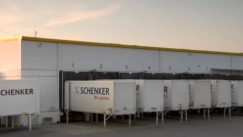 DB Schenker Trailers at Loading Docks in Evening Light for Logistics Video stock 318204014