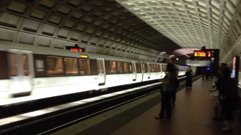 D.C. Metro subway light rail train arrives at station, pan follows, 2nd arrives Stock Footage 266309521