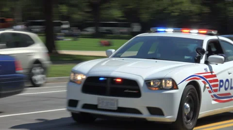 DC police cruiser races past, responding, siren, stock footage Stock Footage