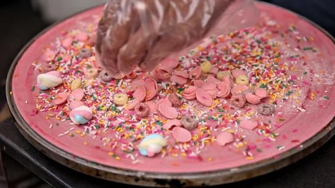 D'crepe is being cooked and added with yuppy candy, street food video Stock Footage 273040613
