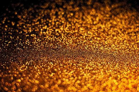 De focused, background of abstract glitter lights. blue, gold and black. Stock Photos