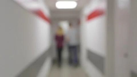De-focused office corridor. People leave the frame Stock Footage 74083337