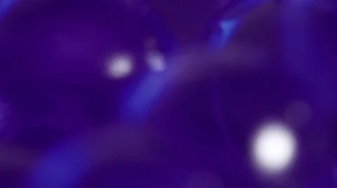 De-focused purple transparent balls on turn table Stock Footage 34870131