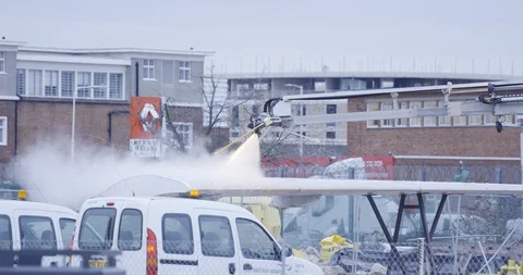 De-icer machine starts de-icing aeroplane wing Stock Footage 114047598