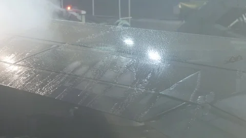 De-icing a airplane wing in winter Stock Footage 99535110