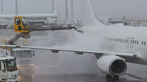 De-icing process of removing snow, ice or frost from an aircraft Stock Footage 135018328