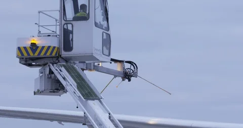 De-icing truck preparing to de-ice the wing of an airplane Stock Footage 114033204