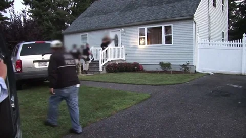 DEA agents raid a house to confiscate prescription drugs. Stock Footage