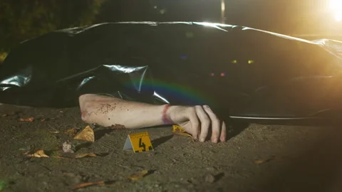 Dead Body under Black Plastic Bag and Forensic Marker on Ground Stock Footage 255358483