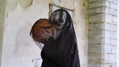 Dead bride is dancing with pumpkin in in the old house. Halloween party. Stock Footage 201200750