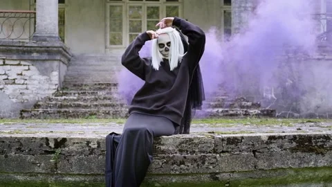 Dead bride sitting in the old house in a blue smoke. Halloween party. Stock Footage 201200773