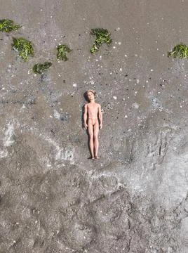 Dead doll on the beach Stock Photos