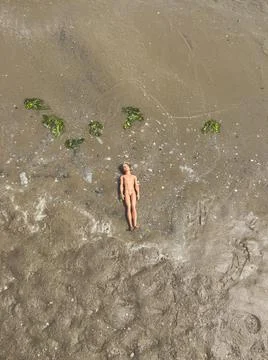 Dead doll on the beach Stock Photos