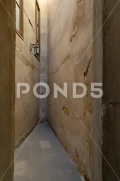 Dead end Narrowing isle with stone grunge walls and lantern Stock Photos
