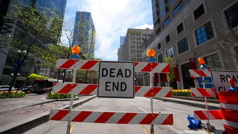 Dead end road sign with construction barricades blocking downtown city street. Stock Footage 334051450