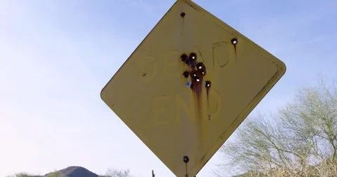 Dead End sign with rusty bullet holes - slider parallax shot Stock Footage 86219838