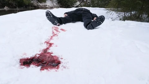 Dead guy lying in the snow with blood trail. Winter murder. Crime scene. Stock Footage 103290876