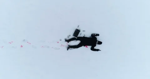 Dead man on snow, camera moves up Stock Footage 99183874