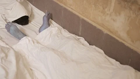 Dead man's foot covered with a sheet. Many victims of coronavirus infected Video stock 217361417