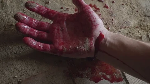 Dead man's hand on the floor. The concept of murder. Halloween Video stock 94813620