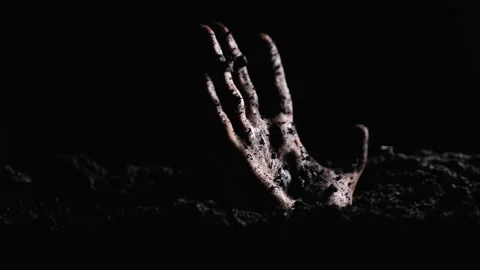 A dead man's hand rises from the ground. A zombie hand rising from the grave Stock Footage 247946259