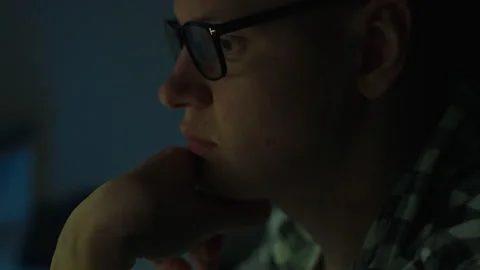 In the dead of night, financial data figures flash on the laptop monitor, a Stock Footage 257712979