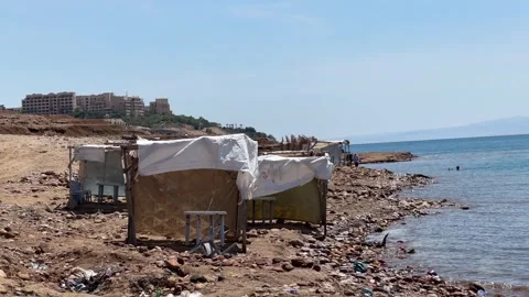 Dead Sea mud bath tourists floating in unsinkable water body Jordan Israel Stock Footage 317515792