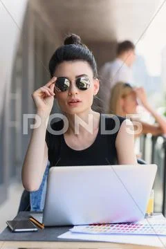 Dead serious woman looking into a camera Stock Photos