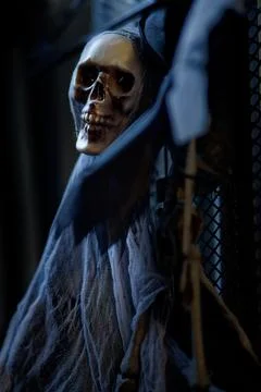 Dead skull of a ghost skeleton with black cloth hanging and looking straight Stock Photos
