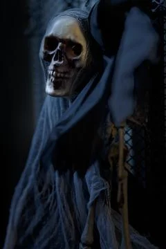Dead skull of a ghost skeleton with black cloth hanging and looking straight Stock Photos
