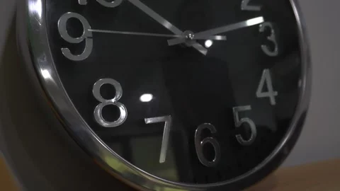 Dead wall clock leaning on wall in office. Reflection of unidentified male Stock Footage 251697679