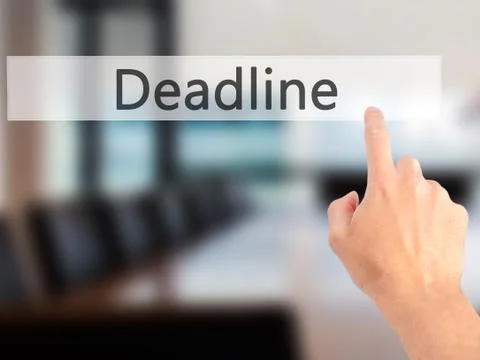 Deadline - Hand pressing a button on blurred background concept on visual scr Stock Photos