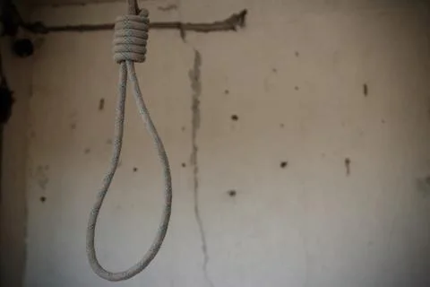 Deadly loop hanging from the ceiling in abandoned apartment. Concept of suicide Stock Photos