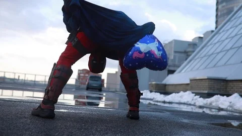 Deadpool cosplayer is having fun and leaning back with a balloon. Stock Footage 111204828