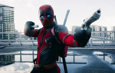 Deadpool cosplayer posing with guns and katanas Stock Photos