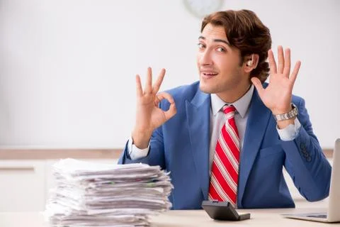 Deaf employee using hearing aid in office Stock Photos