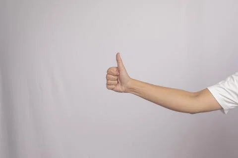 Deaf gesture "Thumb" with hands. "Thumb" gesture in sign language, isolated.. Stock Photos