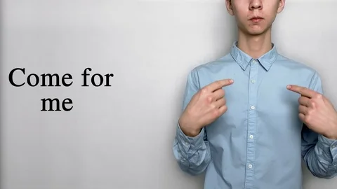 Deaf guy with Asian features in blue shirt on white background saying come Видео 119284786