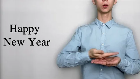 Deaf guy with Asian features in blue shirt on white background saying Happy Xmas Stock Footage 119284788