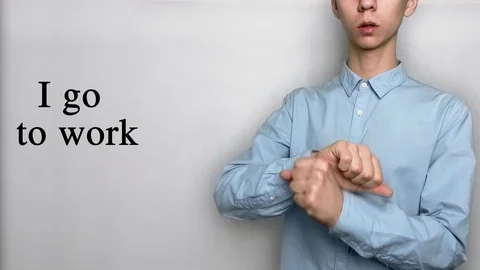 Deaf guy with Asian features in blue shirt on white background saying I go to Stock-Footage 119284796
